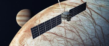 Illustration of NASA's Europa Clipper spacecraft with Jupiter and its icy moon Europa in the background (Credit: NASA/JPL-Caltech)